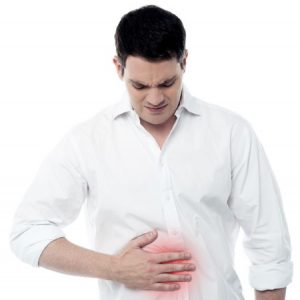 a man holding his stomach after suffering a hernia injury 