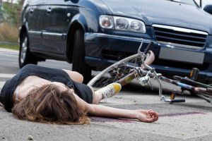 a woman knocked off her bike in a fatal car accident