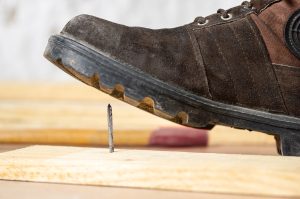a person about to stand on a nail at work