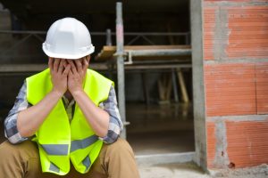 a man holding his face after suffering an eye injury on a construction site