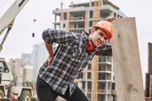 employee-on-construction-site-leaning-over-due-to-back-injury