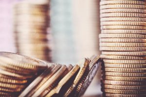 Some coins leaning against a stack of coins.