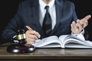 A solicitor sat at a desk with a wooden gavel working on a landlord data breach claim.