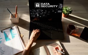A woman is sat in front of her computer learning about cyber security 