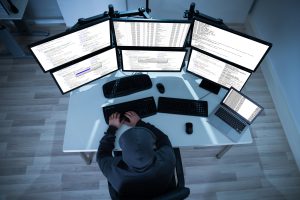 A desk with multiple monitors 