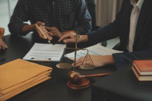 A personal injury solicitor discusses a list of compensation payouts UK with a claimant.