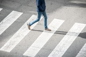 A person using a pedestrian crossing.