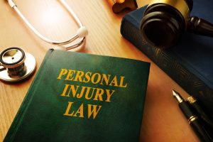  A green book on a desk with 'personal injury law' written on the front of it