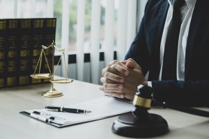 Leg injury compensation solicitor sat at desk.