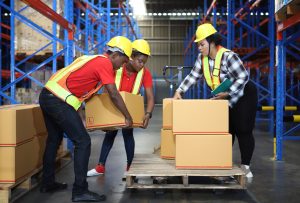 Workers load a lift truck.