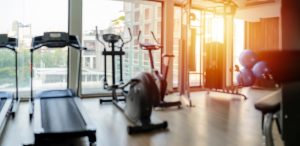 Shot of exercise machines near window.