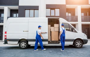 2 workers unload a van.
