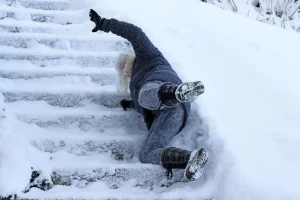 A person has slipped and fallen down icy stairs.