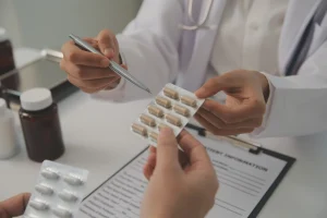 A healthcare worker dispenses medication. 