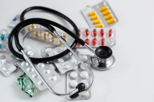 Various medication packets and a stethoscope.