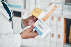 A pharmacist handles medication. 