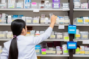 A young woman works in a pharmacy