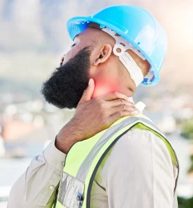 A man in a hi-vis vest and blue hardhat who suffered a neck injury at work. 