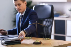 A solicitor calculating data breach compensation amounts for material and non-material damage at their desk