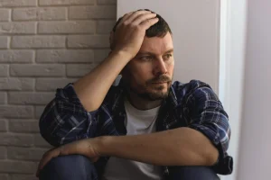 A depressed man looks sad.